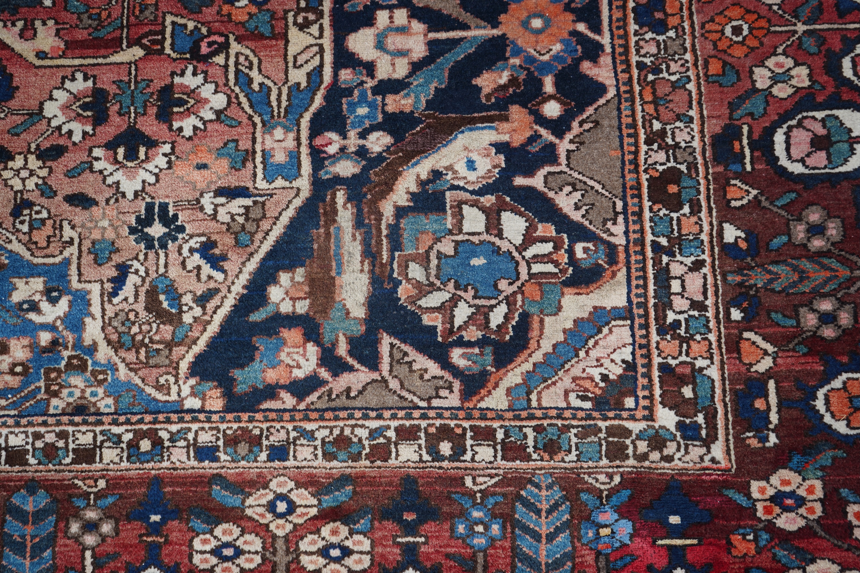 A Heriz brick red ground carpet